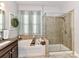 This full bathroom offers a garden tub with tile surround and a glass enclosed shower at 2005 Arbor Hills Dr, Indian Trail, NC 28079