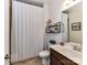 Cozy bathroom featuring a shower with curtain, stylish mirror and shelving and vanity with a sink at 2005 Arbor Hills Dr, Indian Trail, NC 28079