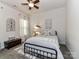 A charming bedroom with a black metal bed frame, ceiling fan, and neutral decor at 2005 Arbor Hills Dr, Indian Trail, NC 28079