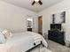 A modern bedroom featuring a ceiling fan, TV, and access to the full bathroom at 2005 Arbor Hills Dr, Indian Trail, NC 28079