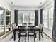 Bright dining area with hardwood flooring, decorative rug, and natural light from sliding glass doors at 2005 Arbor Hills Dr, Indian Trail, NC 28079