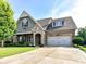 Charming home with a stone facade, well-manicured lawn, and a two-car garage at 2005 Arbor Hills Dr, Indian Trail, NC 28079