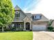 Charming brick and stone home with a well-manicured lawn and inviting front entrance at 2005 Arbor Hills Dr, Indian Trail, NC 28079