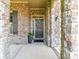 Inviting front entrance with stone archway and brick accents, showcasing a welcoming wreath on the door at 2005 Arbor Hills Dr, Indian Trail, NC 28079