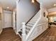 This hallway features hardwood floors, decorative trim, and a staircase at 2005 Arbor Hills Dr, Indian Trail, NC 28079