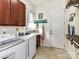 Efficient laundry room with modern washer and dryer, sink, storage, and convenient folding station at 2005 Arbor Hills Dr, Indian Trail, NC 28079