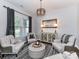 Comfortable living room featuring neutral tones, stylish furnishings, and ample natural light from the windows at 2005 Arbor Hills Dr, Indian Trail, NC 28079