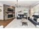 Cozy living room featuring a stone fireplace, comfortable seating, and warm, inviting ambiance at 2005 Arbor Hills Dr, Indian Trail, NC 28079