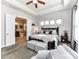 Main bedroom boasts tray ceilings, neutral decor, natural light, and ensuite bathroom access at 2005 Arbor Hills Dr, Indian Trail, NC 28079
