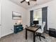 A well-lit home office offers a desk, chair, neutral decor, and bright windows at 2005 Arbor Hills Dr, Indian Trail, NC 28079