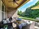 Relaxing covered patio with wicker furniture and a stone fire pit, ideal for outdoor entertaining at 2005 Arbor Hills Dr, Indian Trail, NC 28079