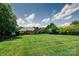 Spacious backyard with a well-maintained lawn and mature trees at 225 Northchase Dr, Concord, NC 28027