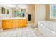 Bathroom with double sinks, large mirror, and soaking tub at 225 Northchase Dr, Concord, NC 28027