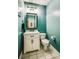 A teal half bathroom features a white vanity with a black faucet and modern lighting at 225 Northchase Dr, Concord, NC 28027