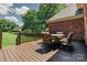 Relaxing deck featuring a dining table and chairs overlooking a large yard at 225 Northchase Dr, Concord, NC 28027