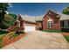 Well-maintained brick home with an attached two-car garage and a paved driveway at 225 Northchase Dr, Concord, NC 28027