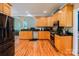 Well-equipped kitchen featuring wood cabinetry, stainless steel appliances, and granite countertops at 225 Northchase Dr, Concord, NC 28027