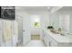 Bright bathroom features double vanity with white countertops and a large mirror, as well as a separate shower at 229 Giant Oak Ave, Statesville, NC 28677