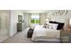 Cozy main bedroom with a cushioned headboard, neutral color scheme, and carpeted floors at 229 Giant Oak Ave, Statesville, NC 28677