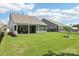 The backyard showcases a covered patio, spacious lawn, black fence, and a community pool at 3022 Trace Meadow Ct, York, SC 29745