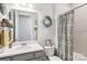 The bathroom features a neutral color palette, a decorative mirror, and tile details at 3022 Trace Meadow Ct, York, SC 29745