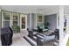 A covered patio area features comfortable seating and stylish decor, perfect for outdoor relaxation and entertaining at 3022 Trace Meadow Ct, York, SC 29745