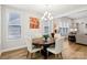 This dining area boasts a wooden table, upholstered chairs, and ample natural light from the windows at 3022 Trace Meadow Ct, York, SC 29745