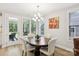 Bright dining area features a stylish chandelier, a wooden table, and outdoor views through the door at 3022 Trace Meadow Ct, York, SC 29745