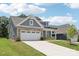 Beautiful home featuring a long driveway, well-maintained lawn, and a mix of siding and brick exterior at 3022 Trace Meadow Ct, York, SC 29745