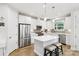 This kitchen features white cabinets, stainless steel appliances, a kitchen island and stylish pendant lighting at 3022 Trace Meadow Ct, York, SC 29745