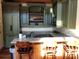 Charming kitchenette featuring granite counters, stylish green cabinets, and wooden bar seating at 3022 Trace Meadow Ct, York, SC 29745