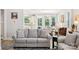 Bright living room with an open concept, hardwood floors, and a glimpse into the modern dining area at 3022 Trace Meadow Ct, York, SC 29745