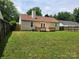 A spacious, fenced backyard with a well-maintained lawn and wooden deck, perfect for outdoor enjoyment at 3106 Faircroft Way, Monroe, NC 28110
