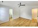 Bright bedroom with a ceiling fan and wood-look floors, with easy access to an en-suite bathroom at 3106 Faircroft Way, Monroe, NC 28110