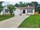 Charming one-story home featuring a long driveway, attached garage, and well-manicured lawn at 3106 Faircroft Way, Monroe, NC 28110