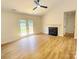 Cozy living room showcasing a fireplace, patio doors, and a ceiling fan, creating a comfortable living space at 3106 Faircroft Way, Monroe, NC 28110