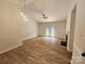 Spacious living room featuring modern light fixtures, fireplace, ceiling fan, and seamless flow to other rooms at 3106 Faircroft Way, Monroe, NC 28110