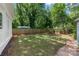 Lush green backyard with manicured lawn, landscaping, and wood privacy fence at 319 Catawba Ave, Rock Hill, SC 29730