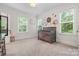 Bright Bedroom with neutral carpet, a gray crib, and three windows at 319 Catawba Ave, Rock Hill, SC 29730