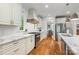 Bright kitchen featuring marble countertops, white cabinetry, stainless steel appliances, and hardwood flooring at 319 Catawba Ave, Rock Hill, SC 29730