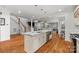 Open concept kitchen island with marble countertop, stainless steel appliances, and hardwood flooring with open view to living room at 319 Catawba Ave, Rock Hill, SC 29730
