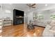 Spacious living room featuring dark fireplace with large screen television and hardwood flooring at 319 Catawba Ave, Rock Hill, SC 29730