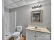 Neutral bathroom features a vanity, mirror, light fixture, toilet, and shower at 408 Camelot Dr, Salisbury, NC 28144