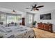 Spacious bedroom featuring hardwood floors, ceiling fans, and windows providing ample natural light at 408 Camelot Dr, Salisbury, NC 28144