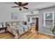 Bright bedroom with hardwood floors, ceiling fan, and large windows offering natural light and views at 408 Camelot Dr, Salisbury, NC 28144