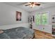Comfortable bedroom with hardwood floors, beadboard wainscoting, natural light, and a ceiling fan at 408 Camelot Dr, Salisbury, NC 28144