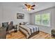 Bright bedroom boasts natural light from large windows, complemented by wood floors and ceiling fan at 408 Camelot Dr, Salisbury, NC 28144