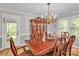 Elegant dining room with wood floors, ornate chandelier, and classic furnishings for hosting gatherings at 408 Camelot Dr, Salisbury, NC 28144