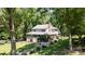 Beautiful home with a welcoming front porch, lush lawn, and driveway, nestled among mature trees at 408 Camelot Dr, Salisbury, NC 28144