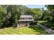 Beautiful home with a welcoming front porch, lush lawn, and driveway, nestled among mature trees at 408 Camelot Dr, Salisbury, NC 28144